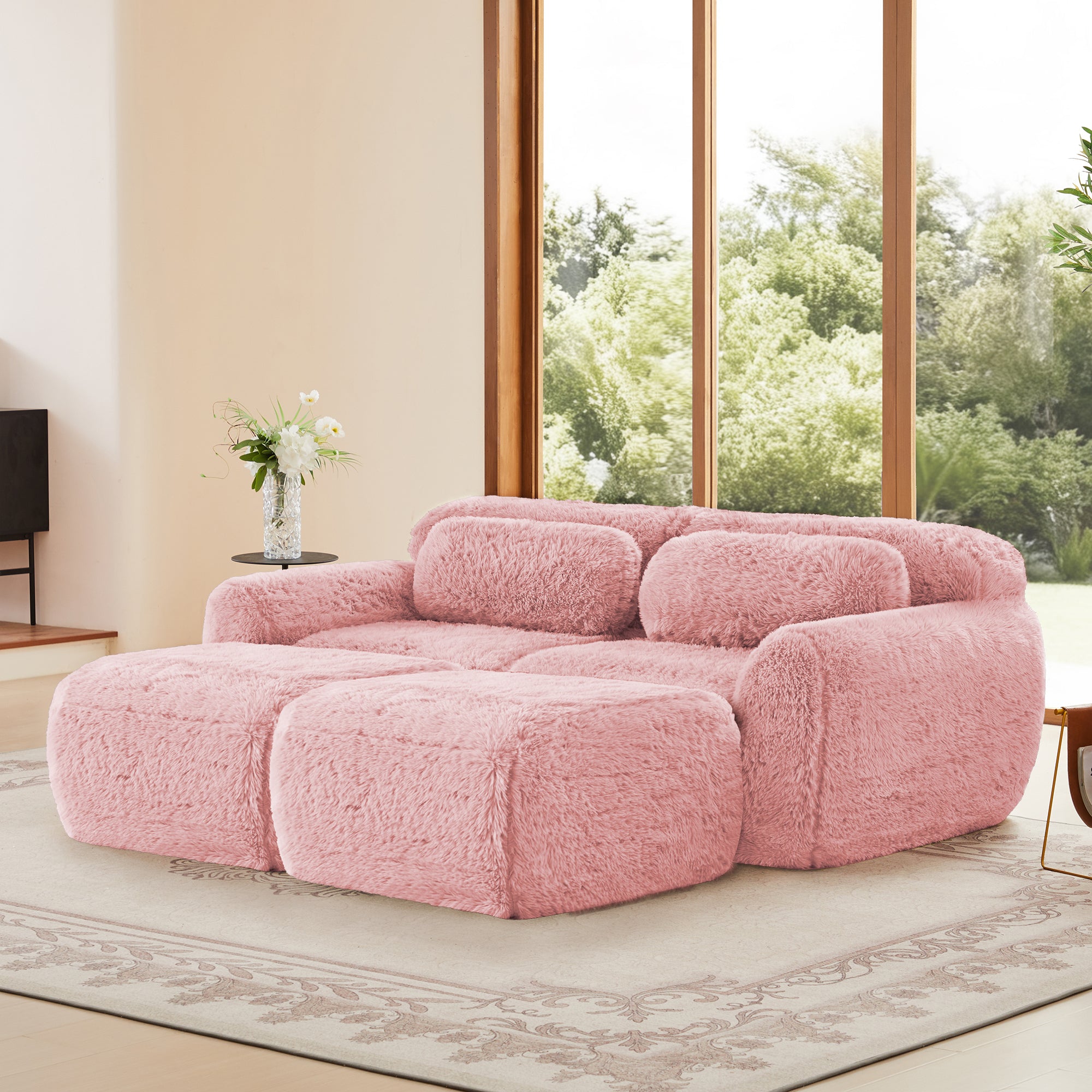 Angled view of pink modular plush sofa with ottoman, highlighting its fluffy design, non-slip bottom, and no-assembly convenience.