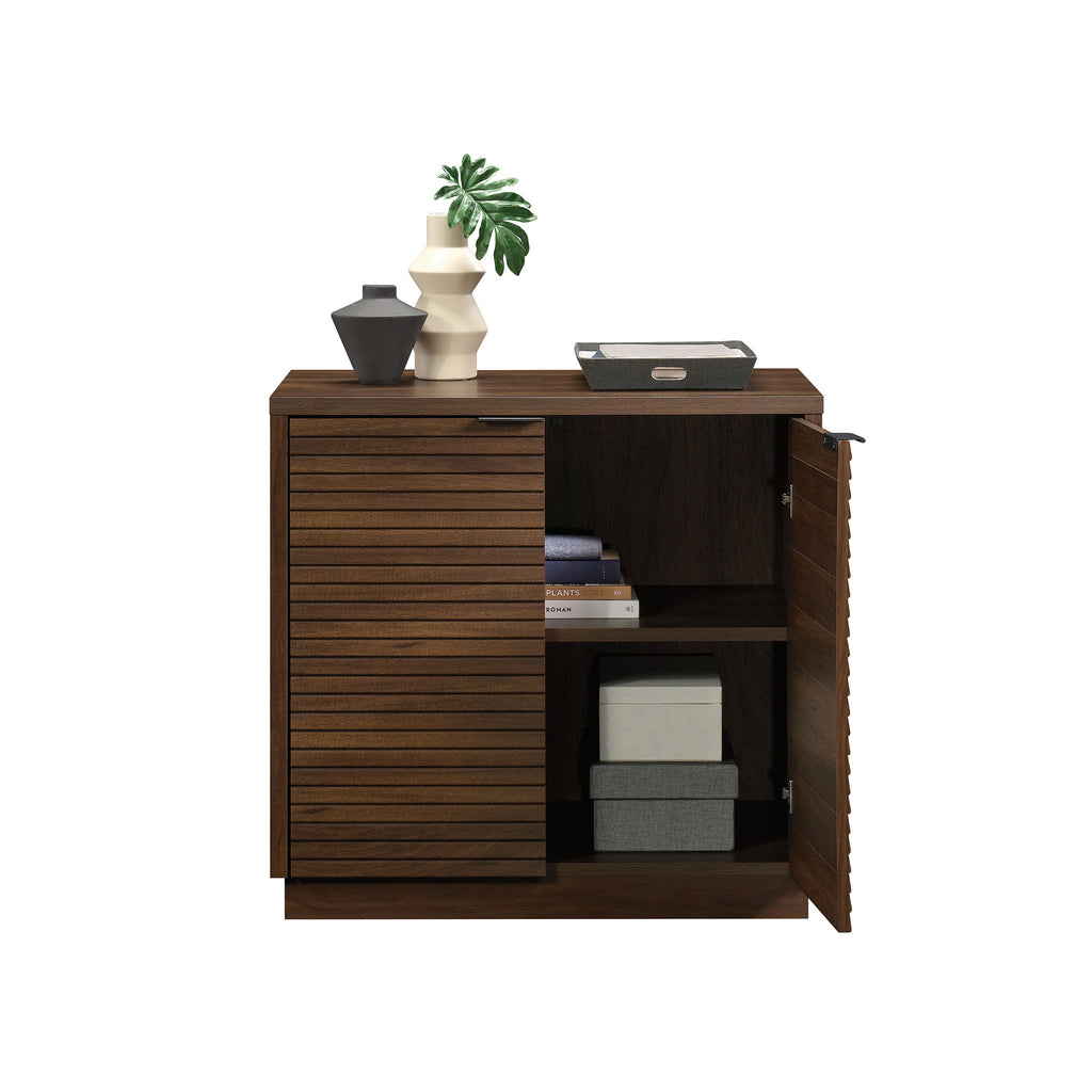 Library Base, Brown finish cabinet with one door open, displaying interior shelves filled with books and storage boxes.