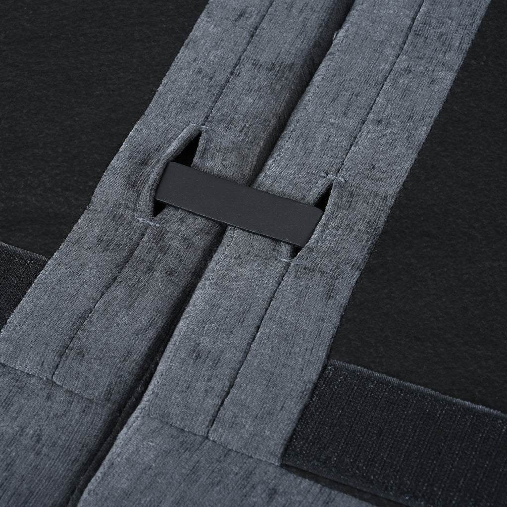 Underside view of modular sofa connection system with secure strap and clip for easy assembly and stability between sections.