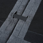 Underside view of modular sofa connection system with secure strap and clip for easy assembly and stability between sections.