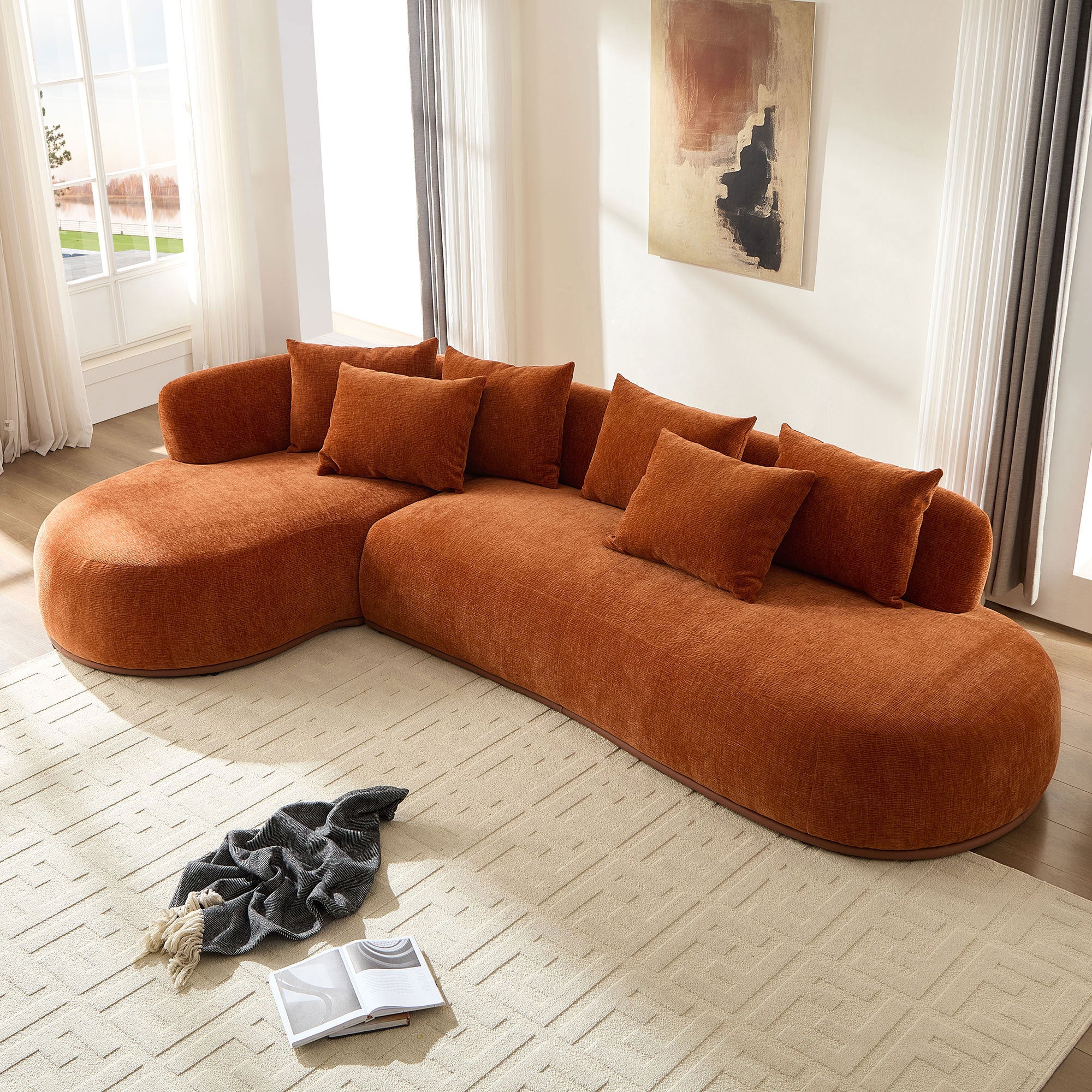 Oversized modern L-shape sectional sofa with chaise in a sunlit living room, featuring plush cushions and deep seating for ultimate comfort.