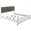 California King bed frame in white wood with dark gray diamond-tufted upholstered headboard and metal supports.
