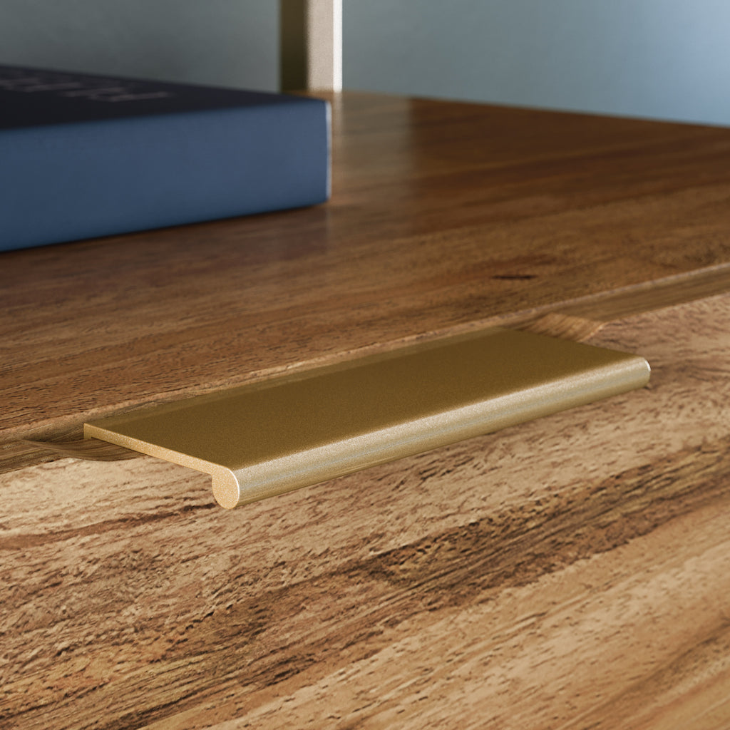 Close-up of gold drawer handle on brown lateral file cabinet, featuring minimalist hardware for a clean, modern look.