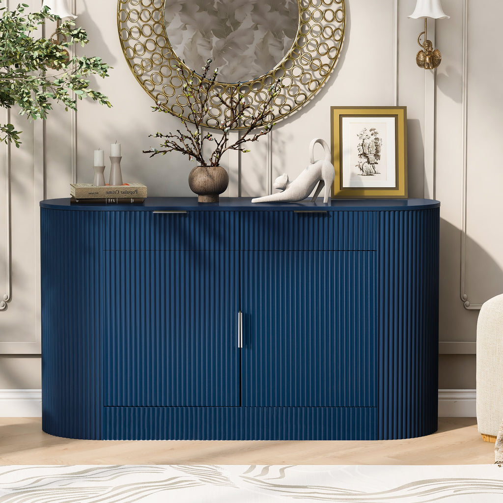 Modern storage cabinet in navy blue MDF with closed curved doors and sleek aluminum handles, placed in a stylish living space.