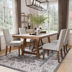 Rustic dining room setup featuring six white upholstered chairs with brown wood legs around a wooden table, cozy and stylish decor.