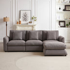 Front view of gray upholstered modular sofa with ottoman, featuring three seats and five matching pillows in a stylish living room.