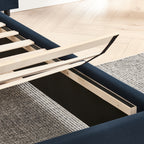 Under-bed storage compartment with lift-up slats on queen upholstered velvet bed frame for practical bedroom organization.