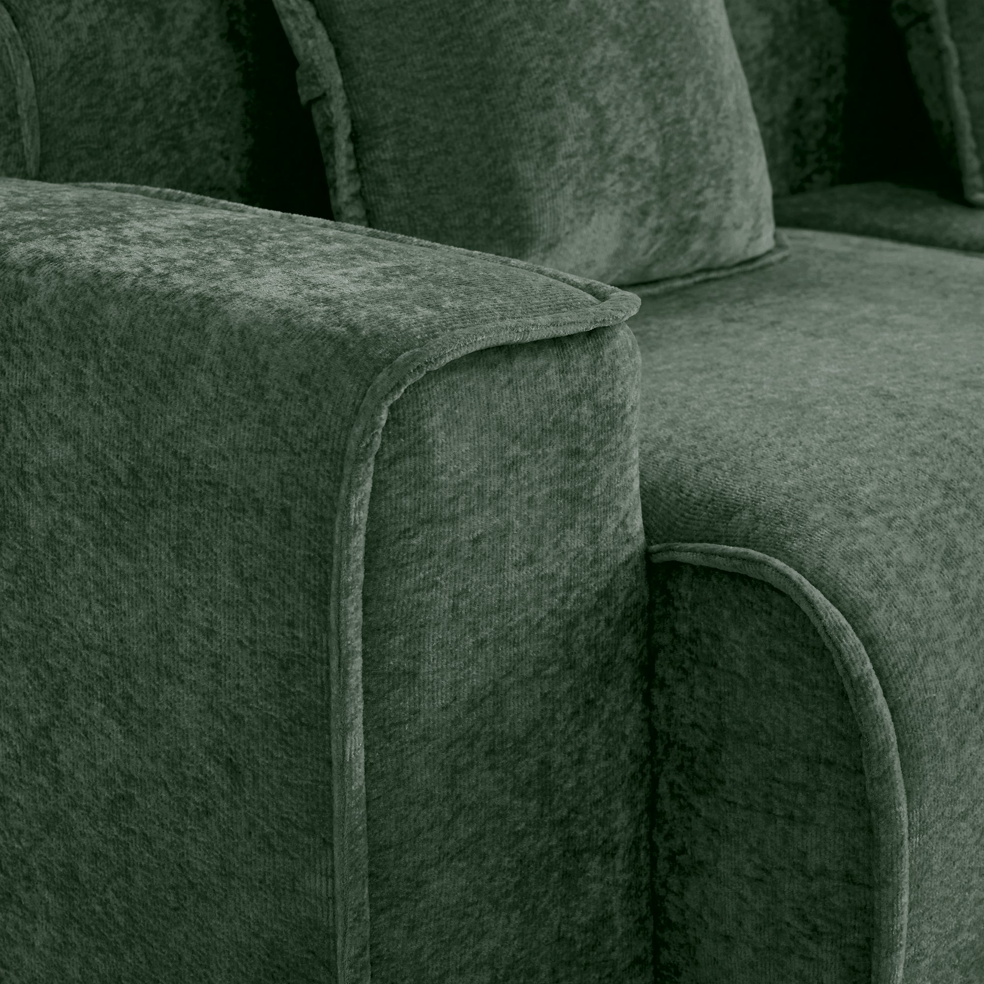 Detailed view of the Modular Green Sofa's velvet fabric and stitching, emphasizing quality craftsmanship and luxurious texture.