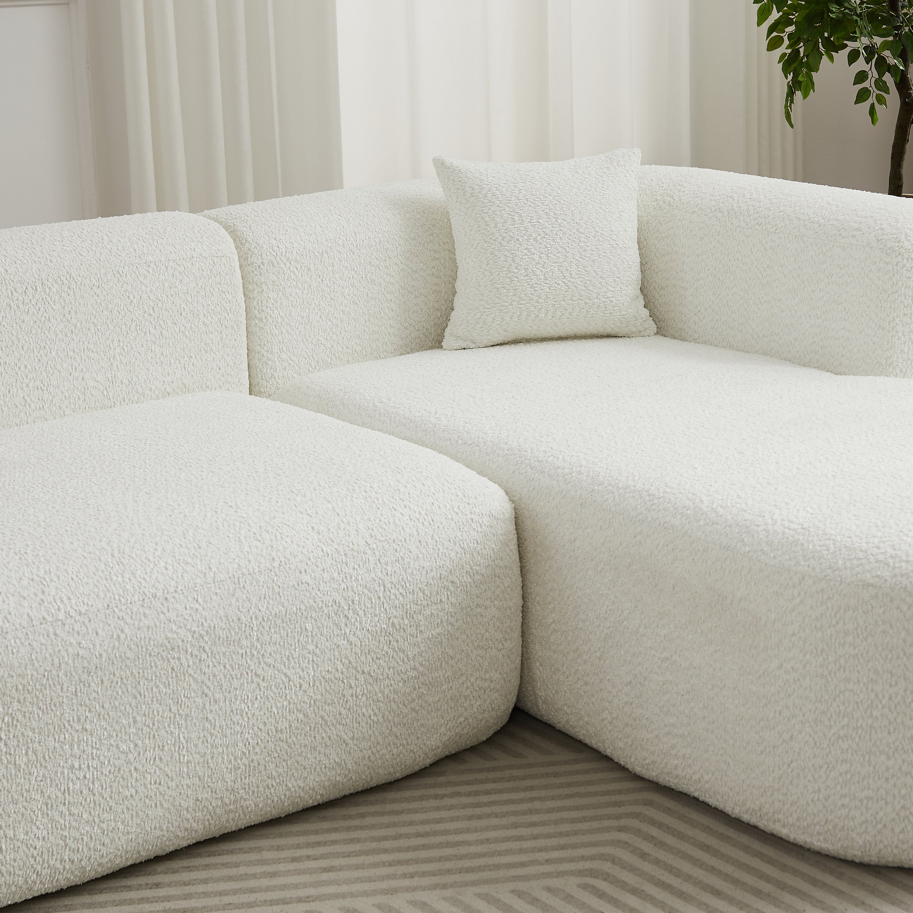 Close-up of the chenille fabric texture and plush cushions on the 109.4' modular sectional sofa in beige.