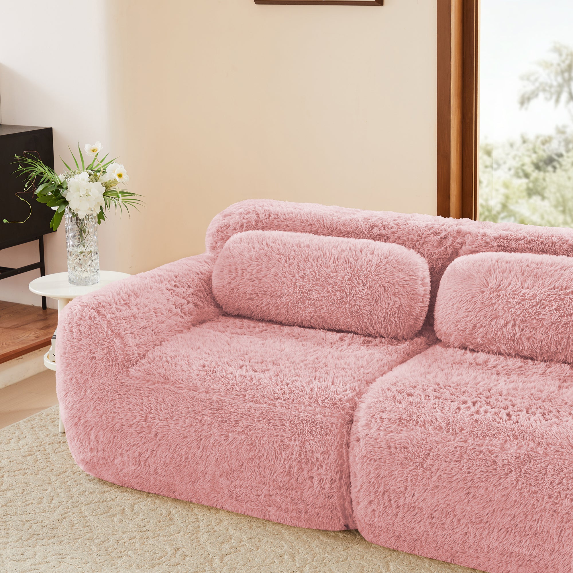 Side view of pink plush modular sofa with anti-slip base and ergonomic backrest, ideal for stylish and comfortable seating.