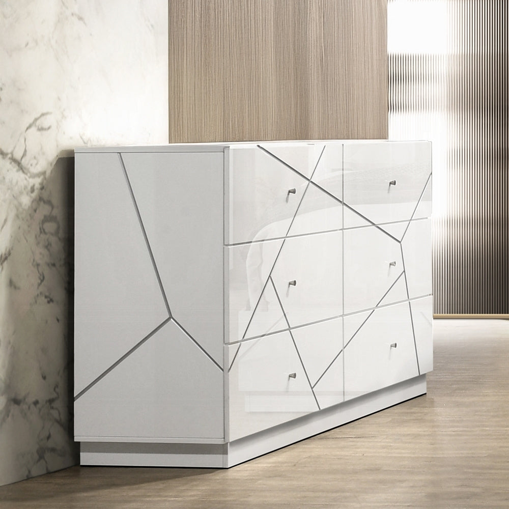 Modern white dresser with 6 drawers and embossed geometric lines in a contemporary bedroom setting. Features sleek metal knobs and glossy finish.