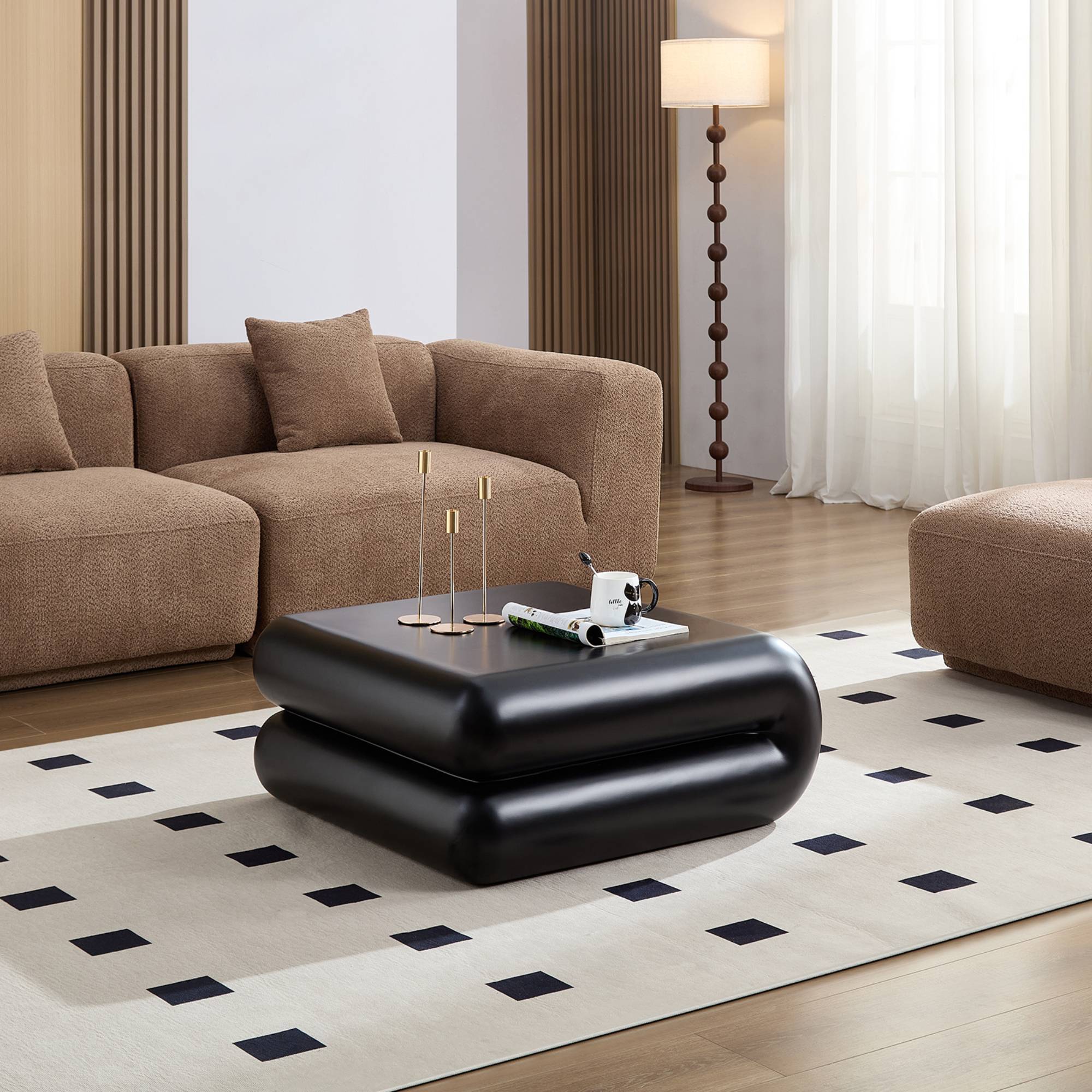 Modern black fiberglass coffee table with stacked design shown in a cozy living room setting, perfect for stylish accent furniture.