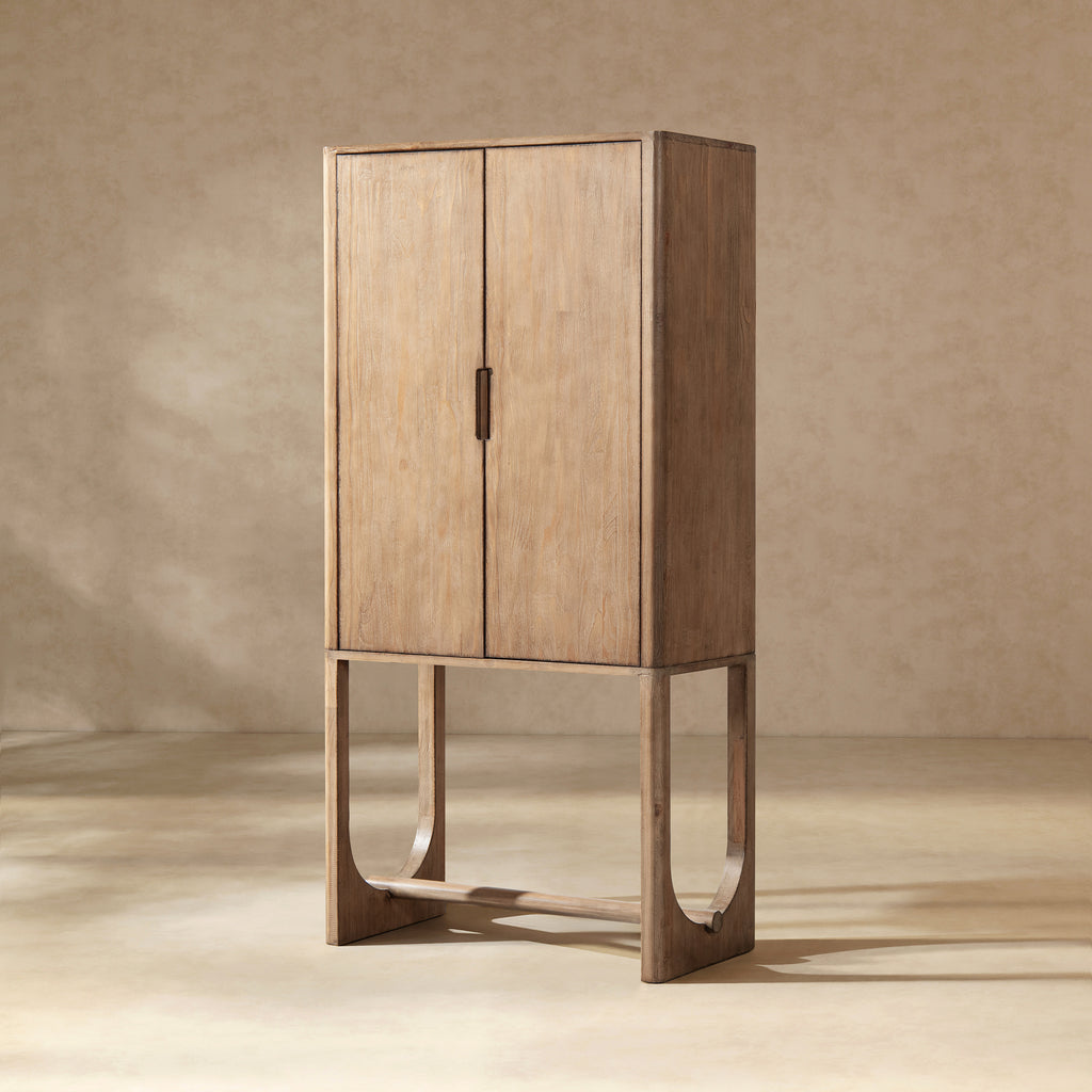 Tall, antique natural brown reclaimed pine bar cabinet featuring minimalist double doors and unique arched base legs.