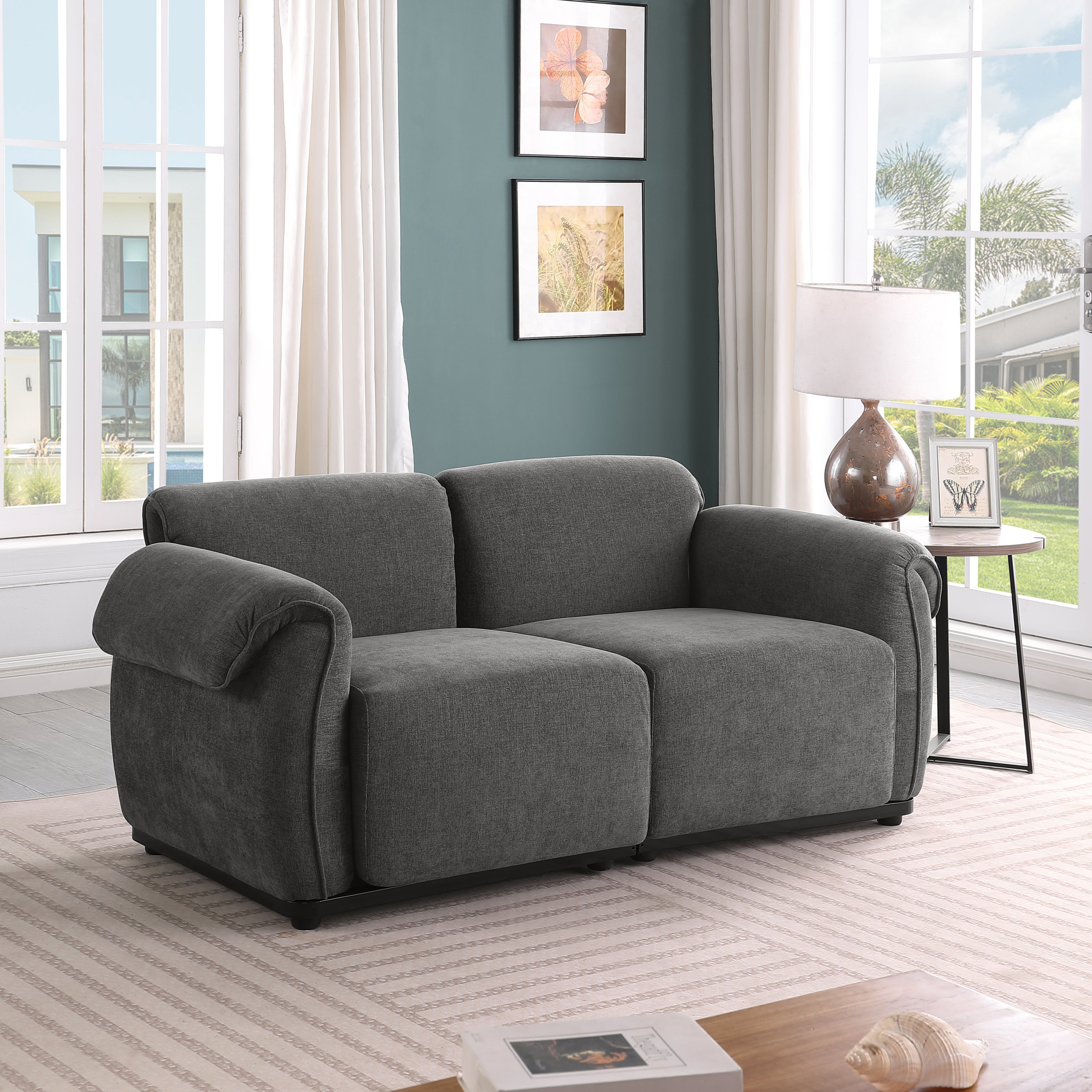 Modern grey chenille modular loveseat with a sturdy iron frame, perfect for a cozy living room setting.