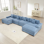 Oversized blue corduroy U-shape modular sectional couch with deep seats, wide armrests, and eight matching throw pillows.