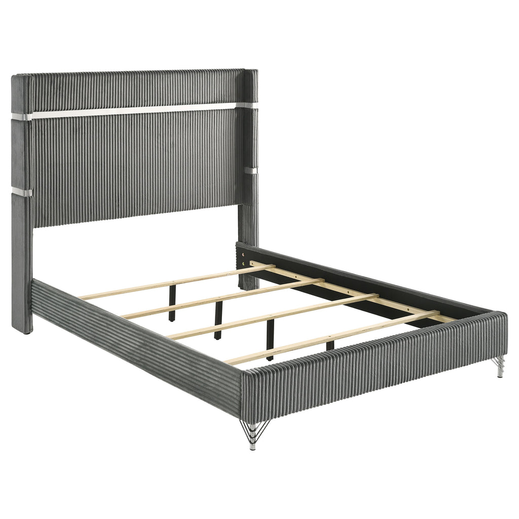 Modern grey velvet queen bed with channel-tufted wingback headboard, metallic accents, and wooden slat support system.