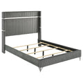 Modern grey velvet queen bed with channel-tufted wingback headboard, metallic accents, and wooden slat support system.