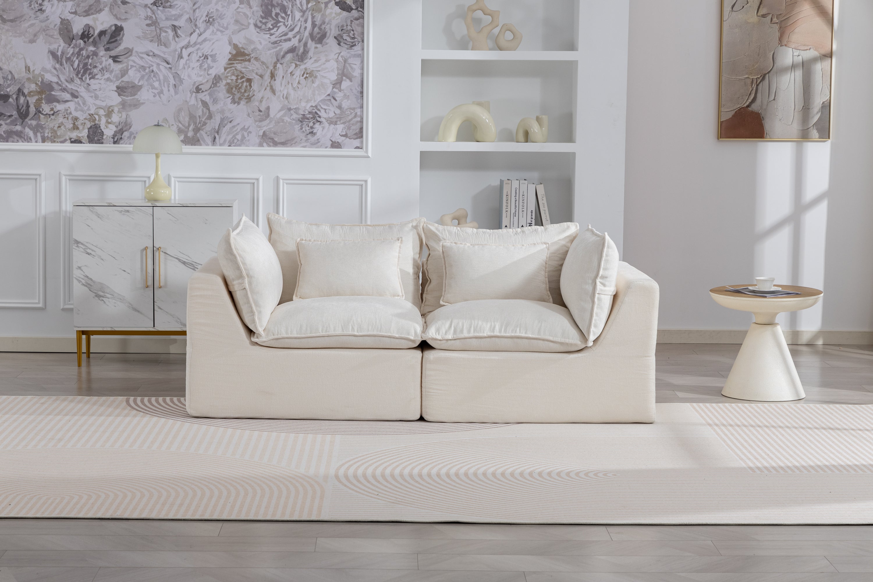 Oversized modular sectional sofa with velvet upholstery styled in a bright living room, showcasing its adaptable and cozy design.