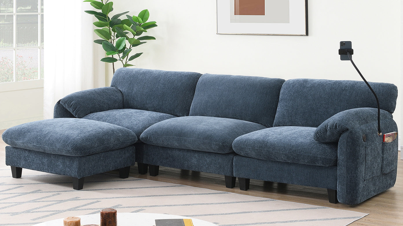 Spacious blue sectional sofa with chaise lounge and USB charging port. Ideal for cozy living rooms with modern decor and natural lighting.