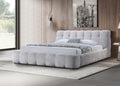 Modern queen bed upholstered in gray chenille fabric, featuring a plush, channeled tufted headboard and low-profile frame.