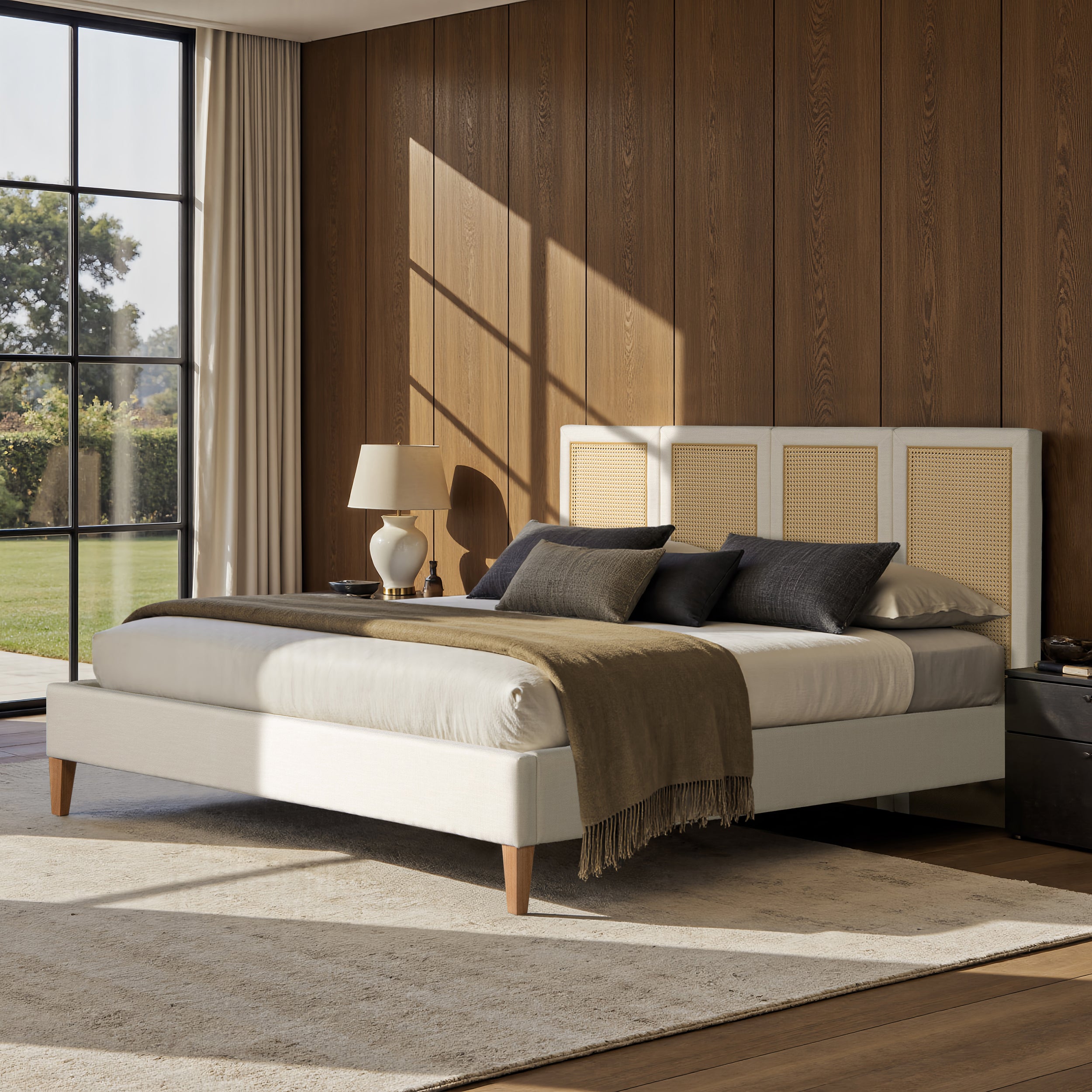 Toscana King Cane Bed with upholstered frame and rattan panels, placed in a modern wood-paneled bedroom with minimalist decor.