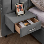 Open drawer of floating nightstand attached to velvet queen bed frame, showing storage space and modern handle design.