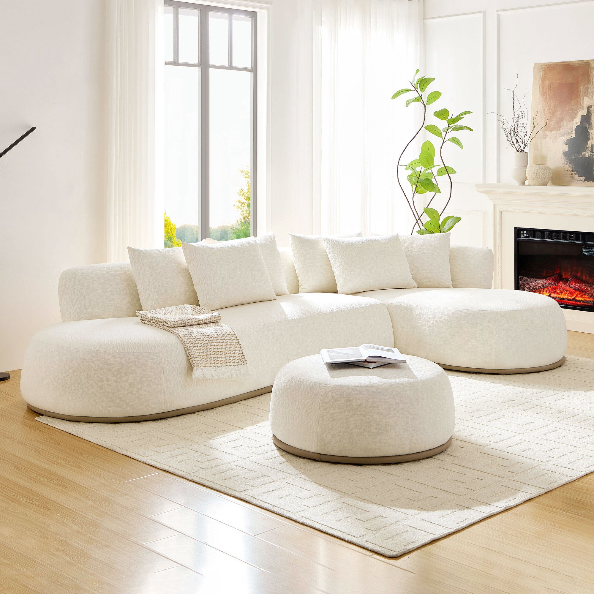 Beige oversized L-shape sectional sofa with ottoman in a sunlit modern living room, offering cozy seating for five and elegant decor appeal.