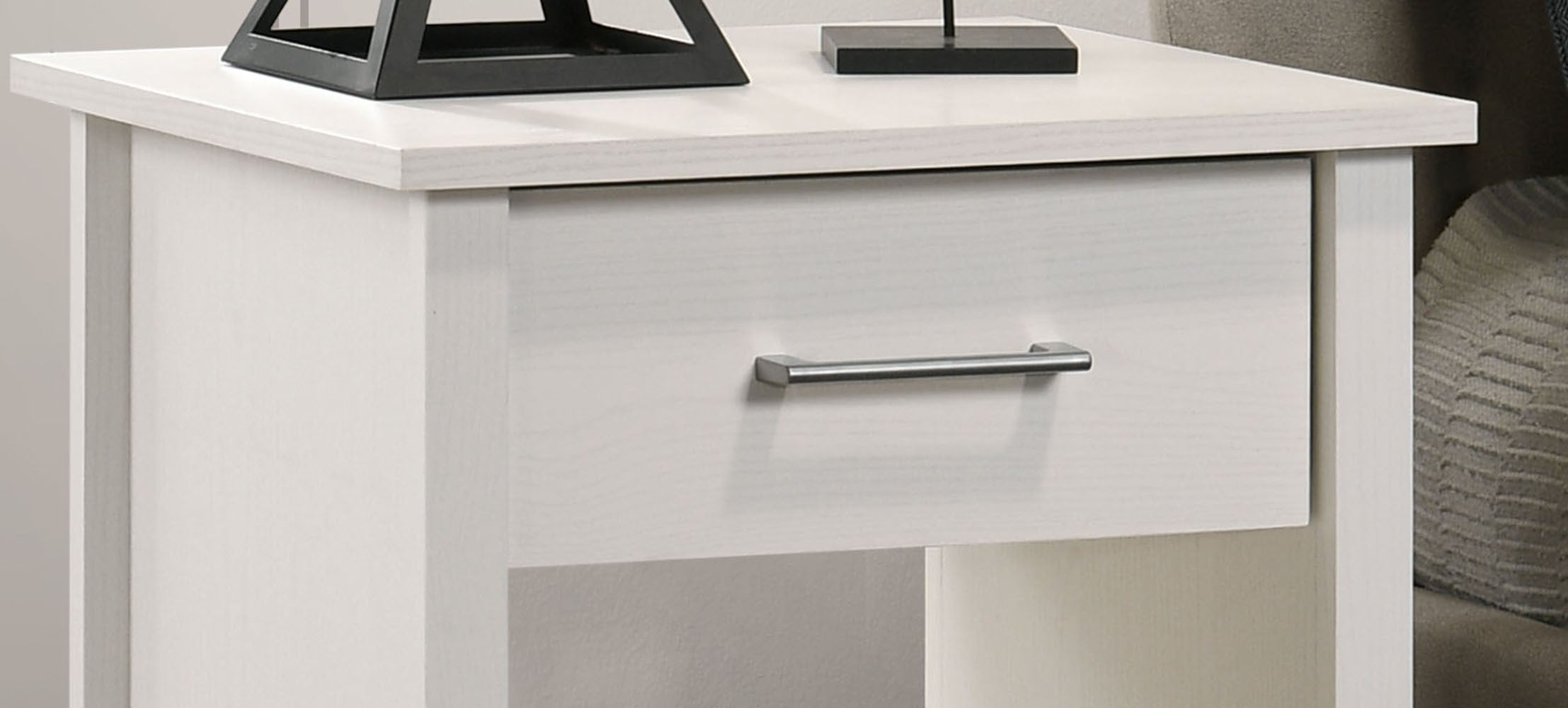 Top drawer of Celeste White Nightstand with sleek metal handle. Minimalist design ideal for modern bedroom storage.