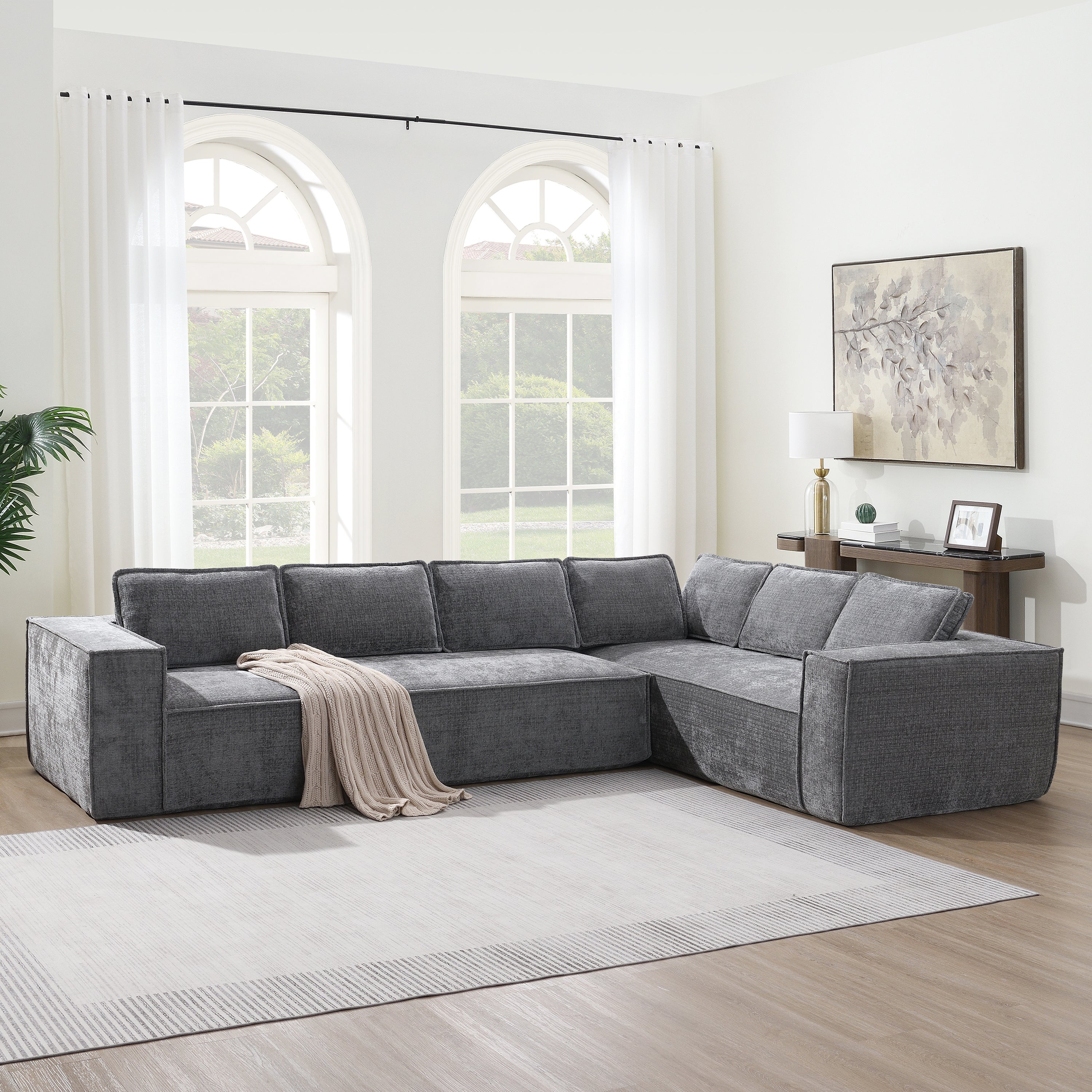 Modular sectional sofa - chenille 6-seater L-shape in gray, placed in a bright living room with large windows and a neutral rug.