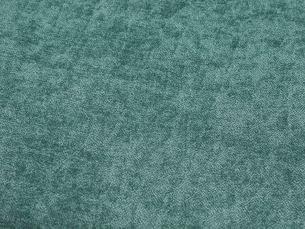 Close-up texture of green upholstery fabric used on chairs in the walnut dining set, offering a soft and stylish seating experience.