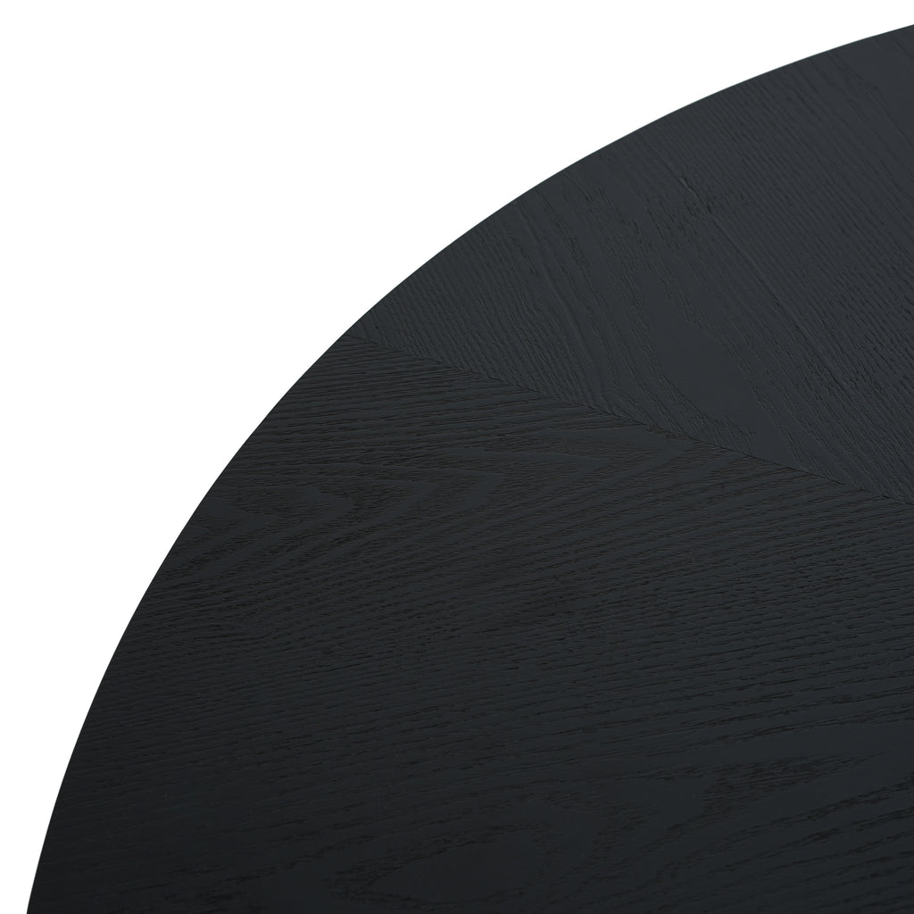 Detail of black round tabletop edge with wood grain finish. Smooth and sleek design complements modern interiors.