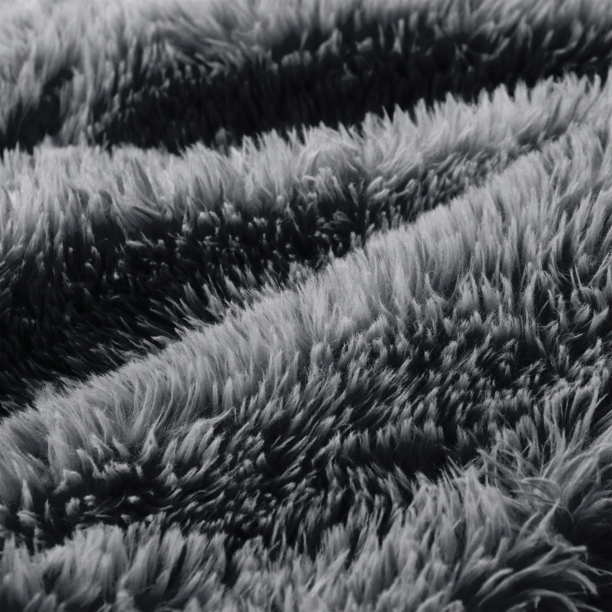 Detailed texture of plush dark grey fabric on the modular sofa, showcasing its cozy and inviting surface for lounging.