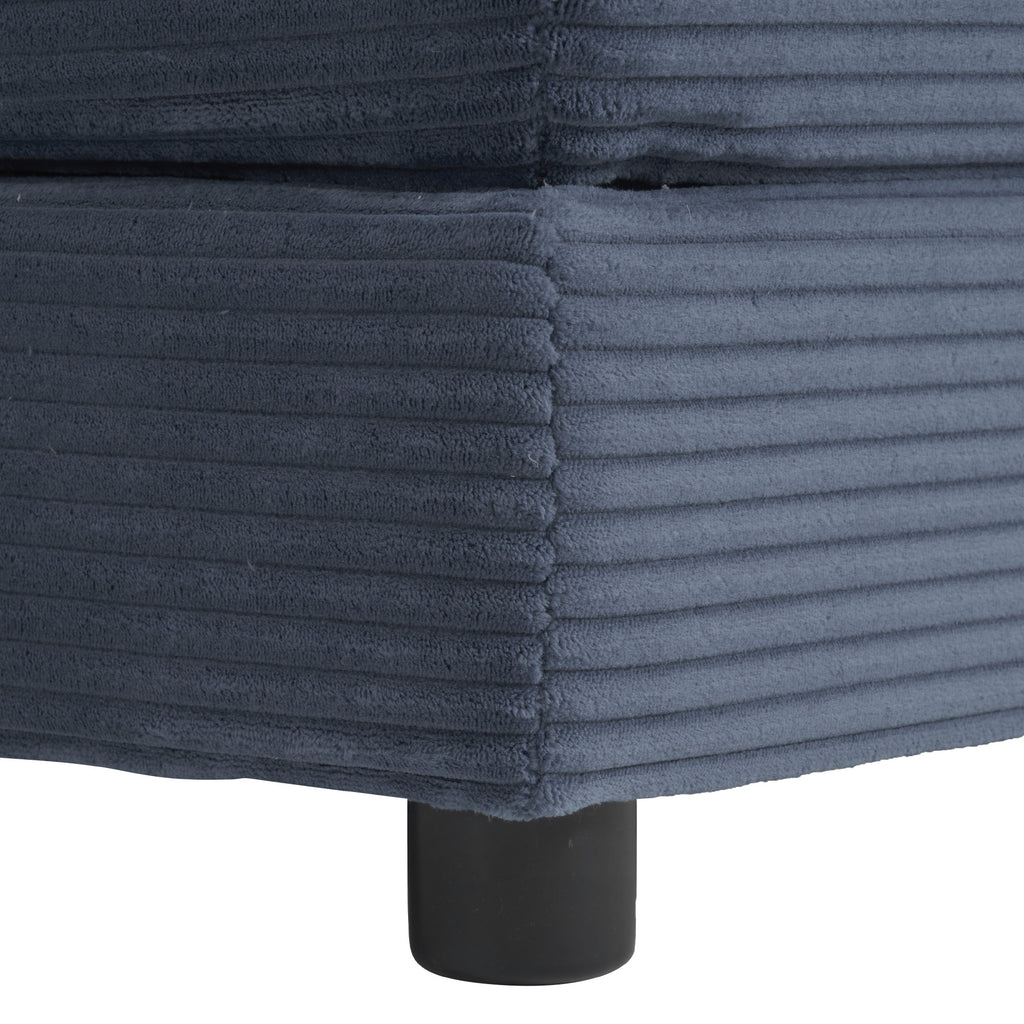 Detail of the sofa base with ribbed blue corduroy fabric and black cylindrical leg. Highlights quality craftsmanship and stable support.