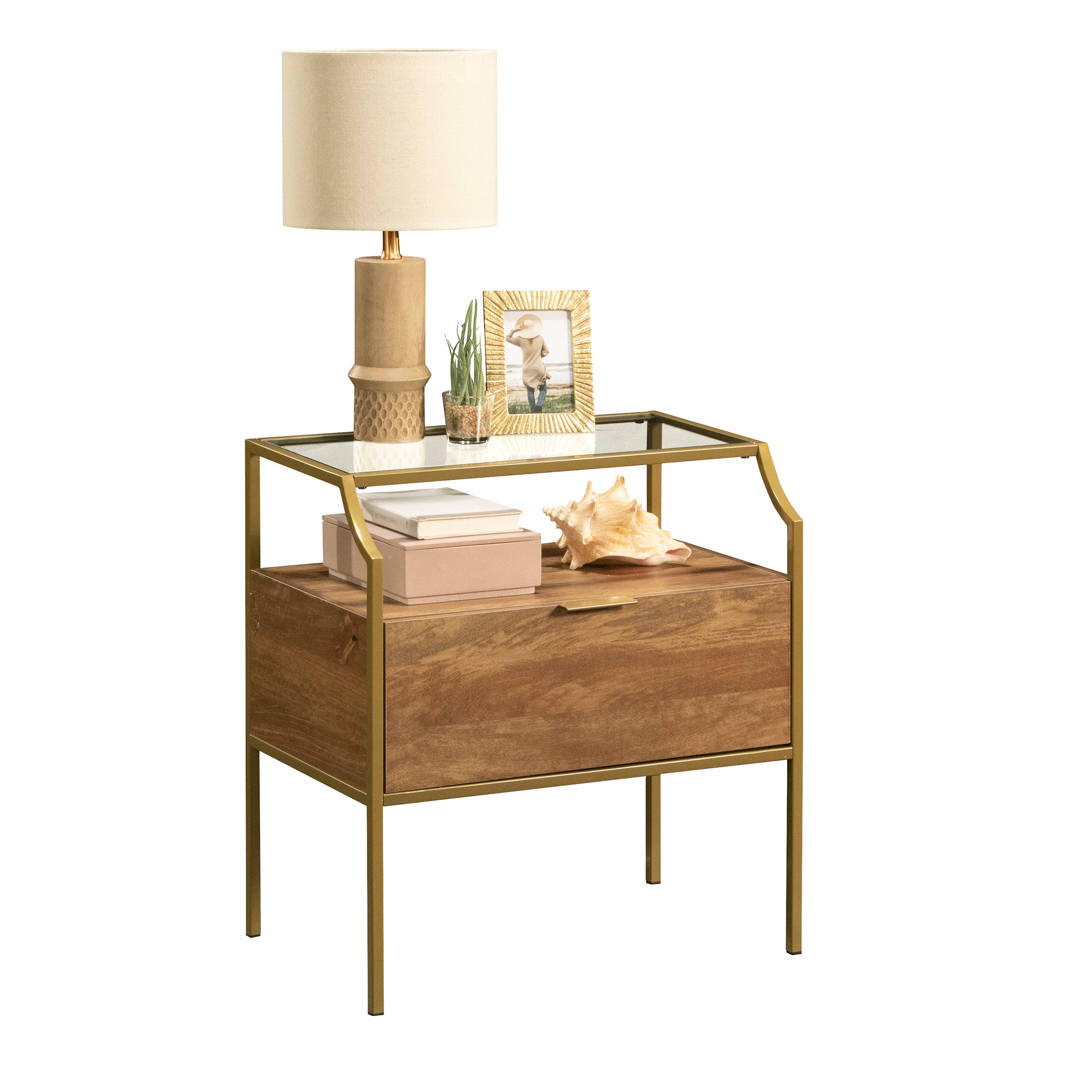Brown finish night stand styled with lamp and decor, featuring a glass top and open shelf for modern bedroom use.
