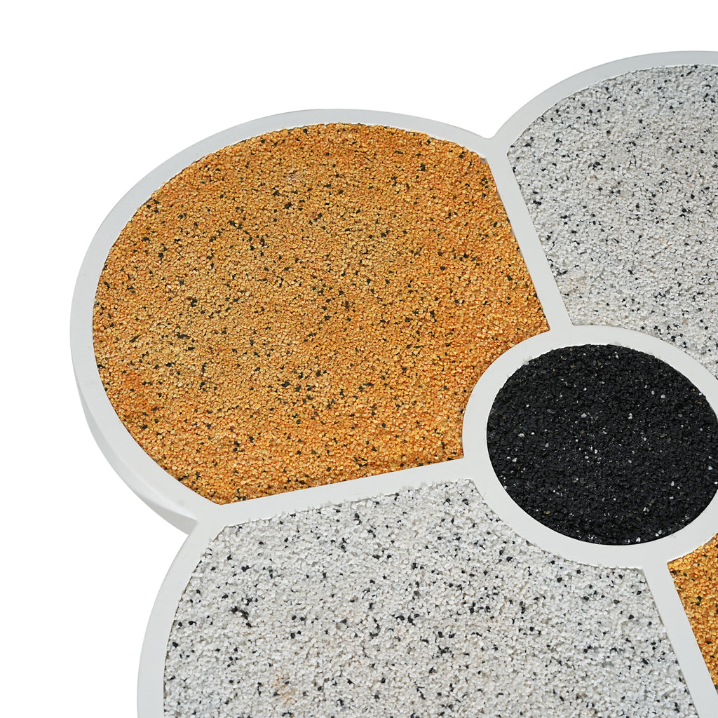 Detailed view of the terrazzo tabletop on the clover-shaped accent table, highlighting the textured gold and white segments.