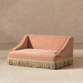 Peach orange performance velvet pet sofa with elegant rolled arms and a decorative cream-colored fringe base.
