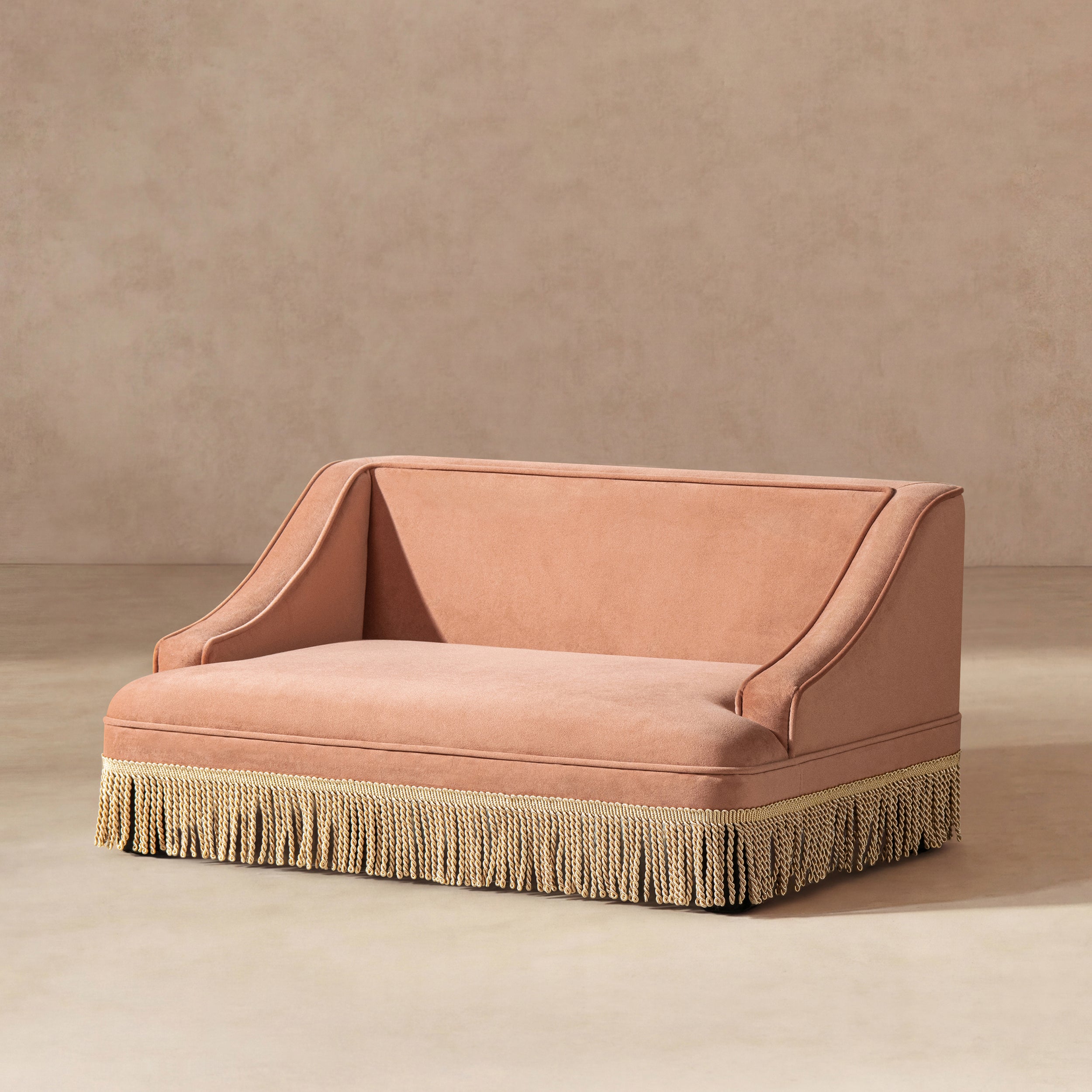 Peach orange performance velvet pet sofa with elegant rolled arms and a decorative cream-colored fringe base.