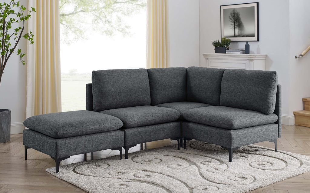 Dark gray linen modular sectional sofa with plush cushions and sleek black metal legs on a patterned area rug.