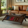 Mid-Century Modern Coffee Table in Morocco Brown with glass top and angled wood frame, styled in a cozy living room with leather sofa.