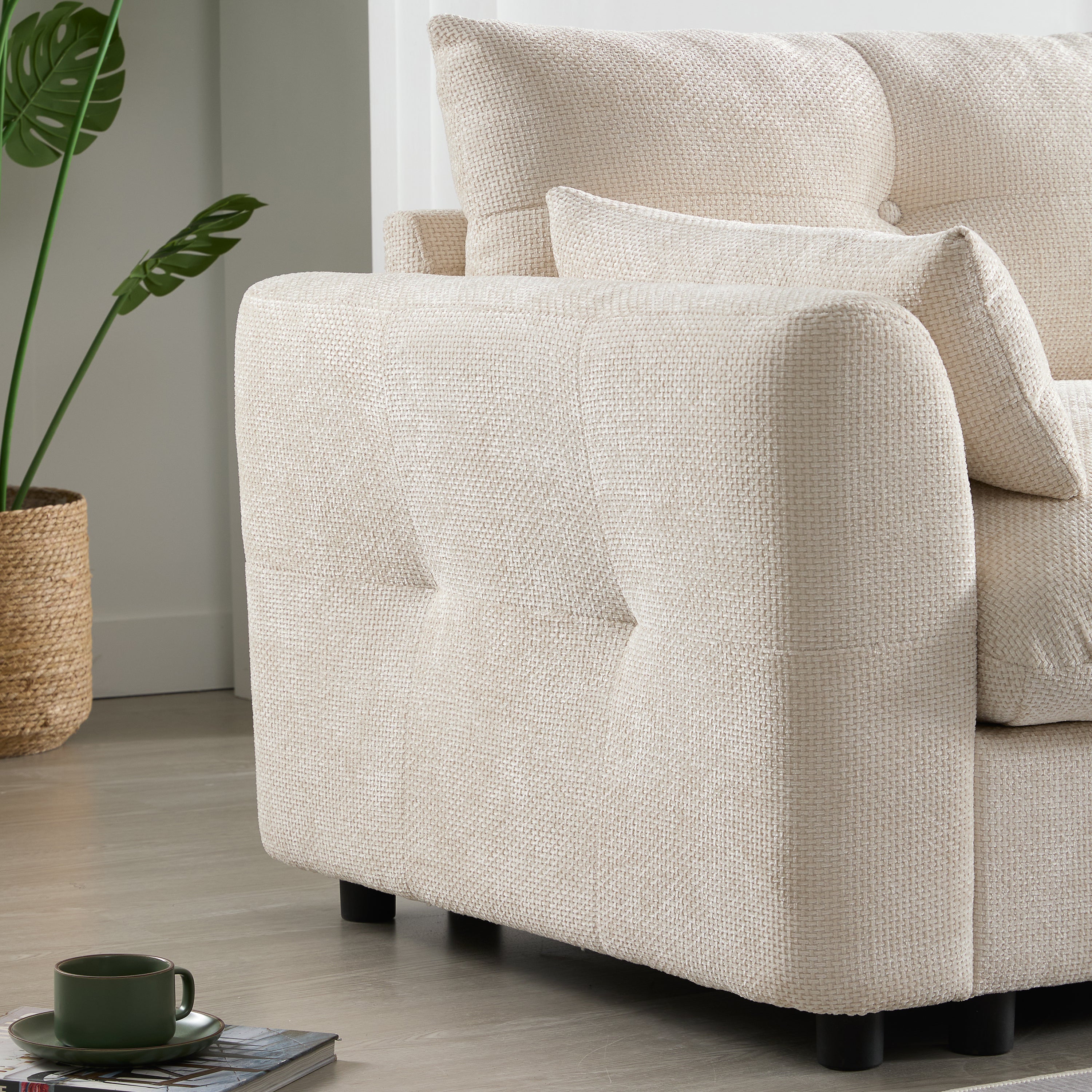 Side view of modular sectional sofa armrest with tufted design and soft cushion. Adds elegance to modern living room seating.