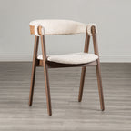 Mid-Century Modern Side Chair in Walnut & Beige with boucle fabric, curved backrest, and angled wooden legs on a wood floor.