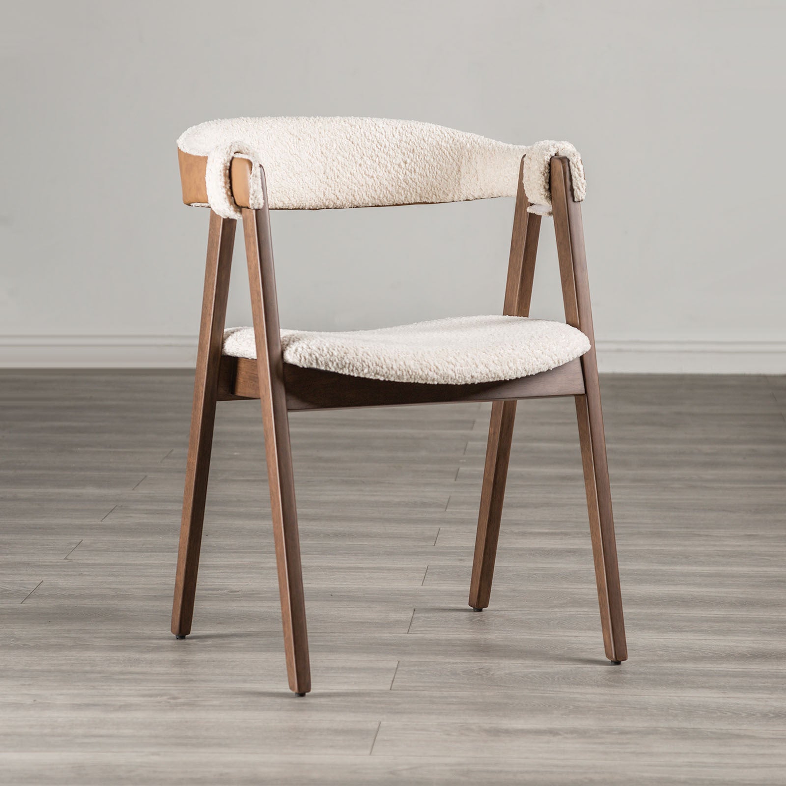 Mid-Century Modern Side Chair in Walnut & Beige with boucle fabric, curved backrest, and angled wooden legs on a wood floor.