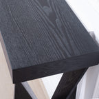 Close-up of black wood grain tabletop on modern console table, highlighting its textured finish and craftsmanship.