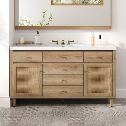 Bathroom vanity with wooden cabinets, white countertop, and decorative items.