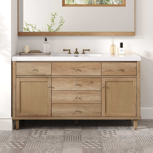 Bathroom vanity with wooden cabinets, white countertop, and decorative items.