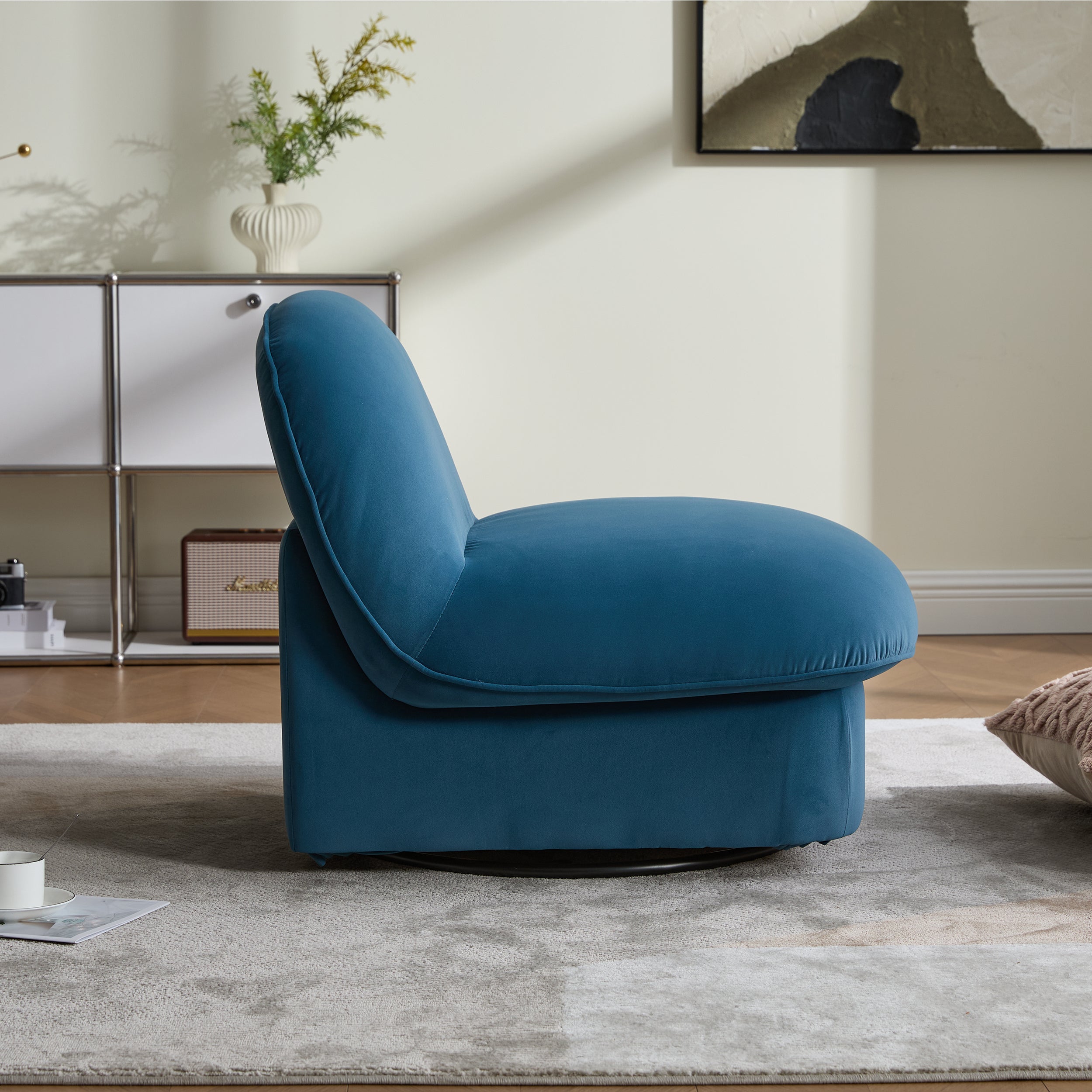 Side profile of velvet swivel accent chair showing thick cushioned seat and armless design on a 360-degree metal base.