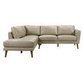 Mid-century modern beige leather sectional sofa with a left-facing chaise and tapered wooden legs.