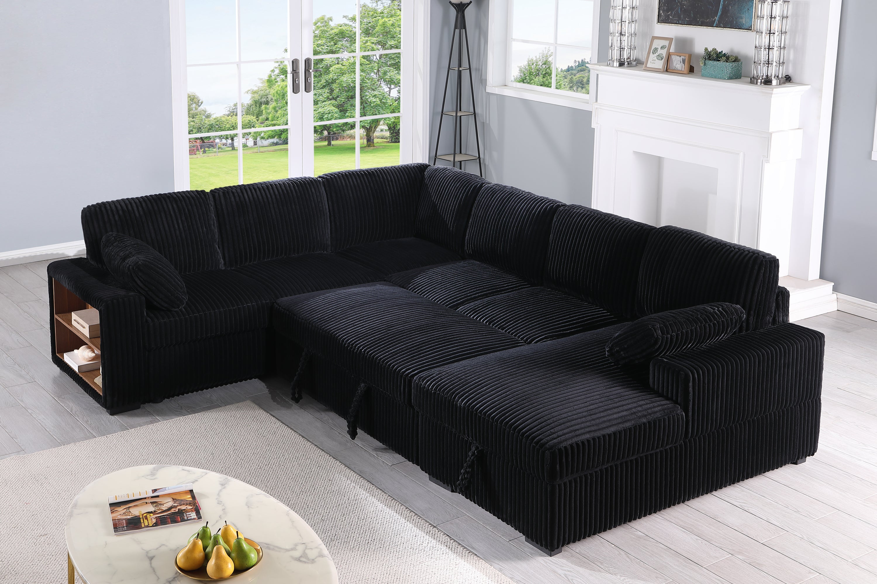 Convertible sectional sofa bed in plush black corduroy, extended into sleeper position for day-to-night functionality and comfort.