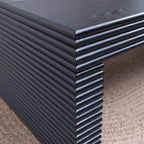 Close-up of ribbed leg detailing on 47.6 modern black coffee table, emphasizing its textured craftsmanship and modern design.