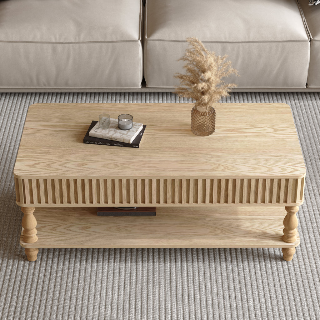 Top view of closed lift top coffee table with fluted wood detailing and decorative items, ideal for stylish storage solutions.